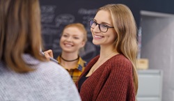 Adults smiling at each other in meeting