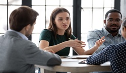 Adults in meeting at table